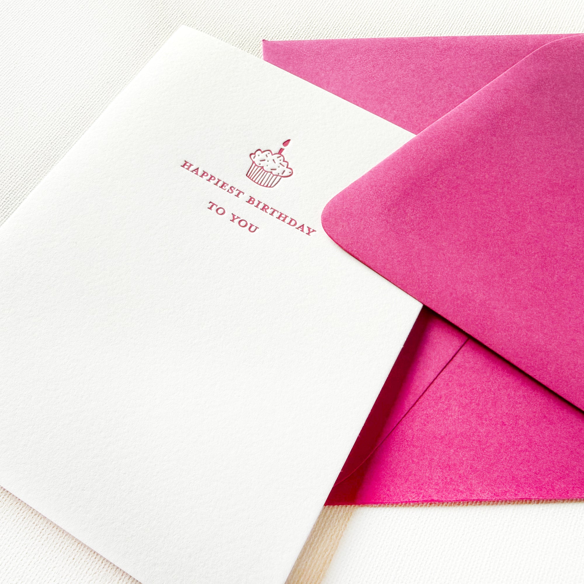 happiest birthday to you with pink cupcake illustration 

letterpress happiest birthday to you greeting card