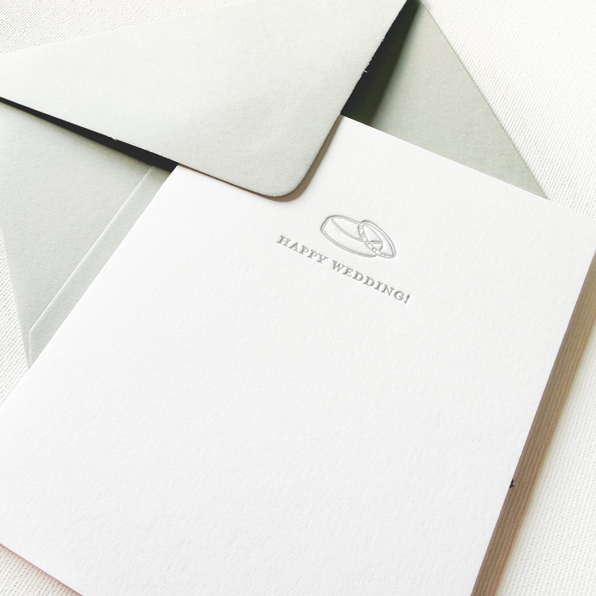 letterpress happy wedding card with hand drawn ring and paired with a gray envelope