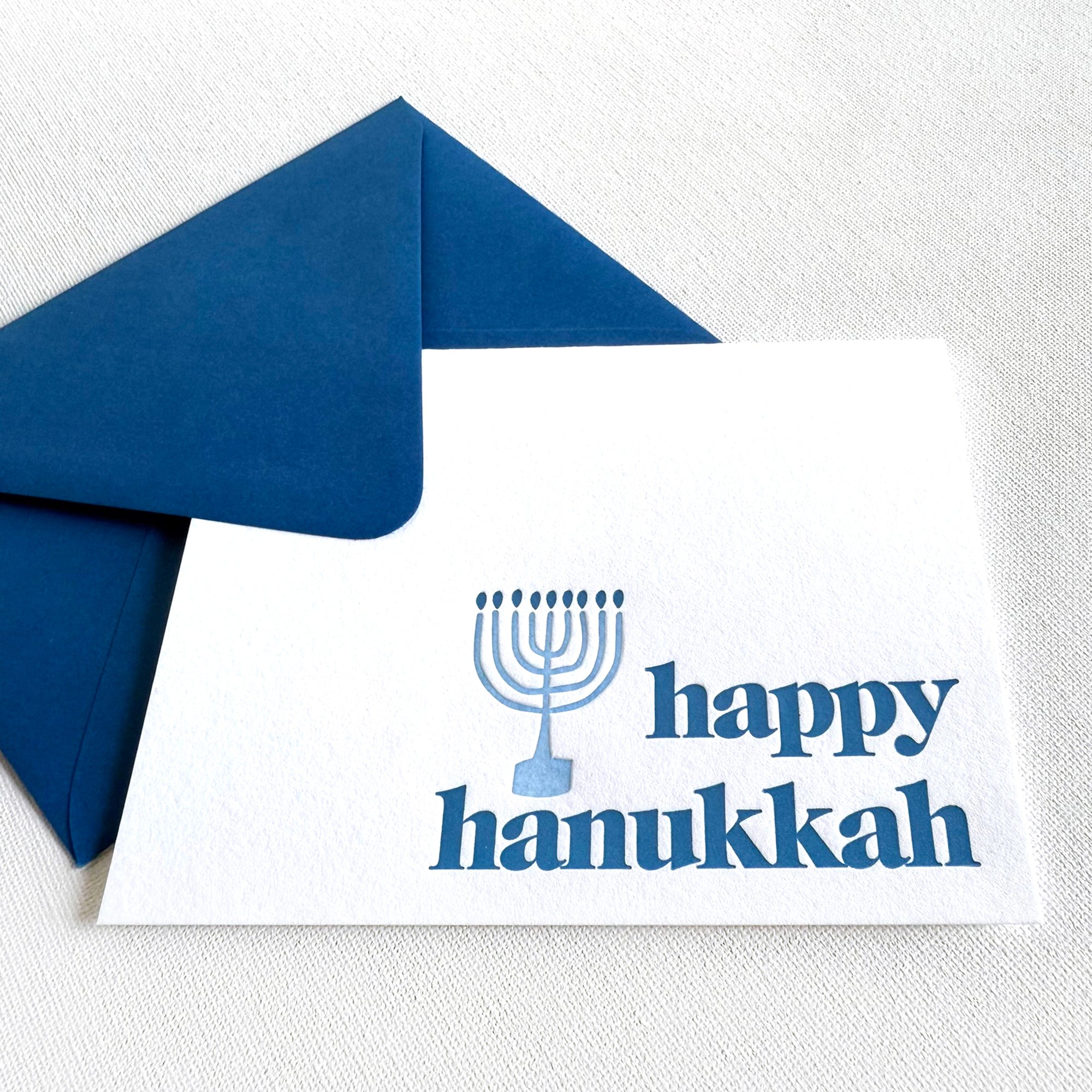 Happy Hanukkah card with blue Menorah design and matching blue envelope

happy hanukkah letterpress card

menorah letterpress hanukkah card