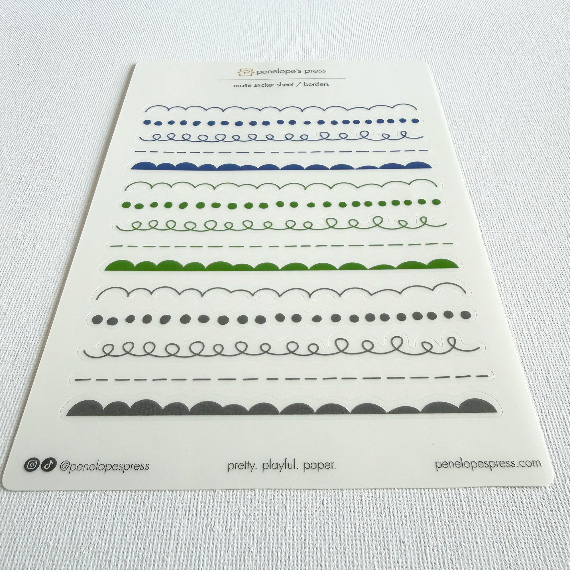 Sheet of decorative border designs with Penelope's Press branding on a white background