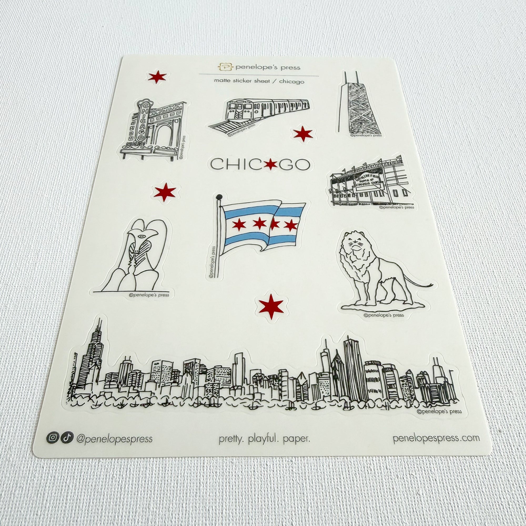 Sheet of Chicago-themed stickers with skyline, flag, and landmarks on a white background. 5x7" stickers sheet of chicago themed illustrations