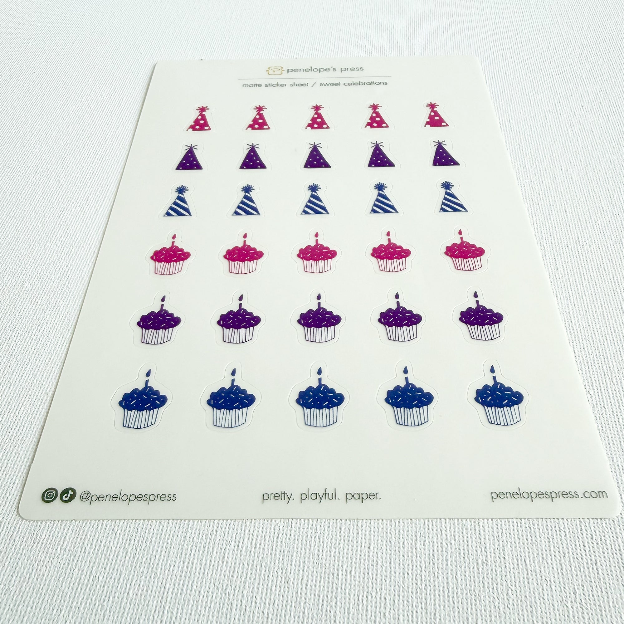 Sheet of decorative stickers featuring birthday hats, cupcakes, and candles on a white background.