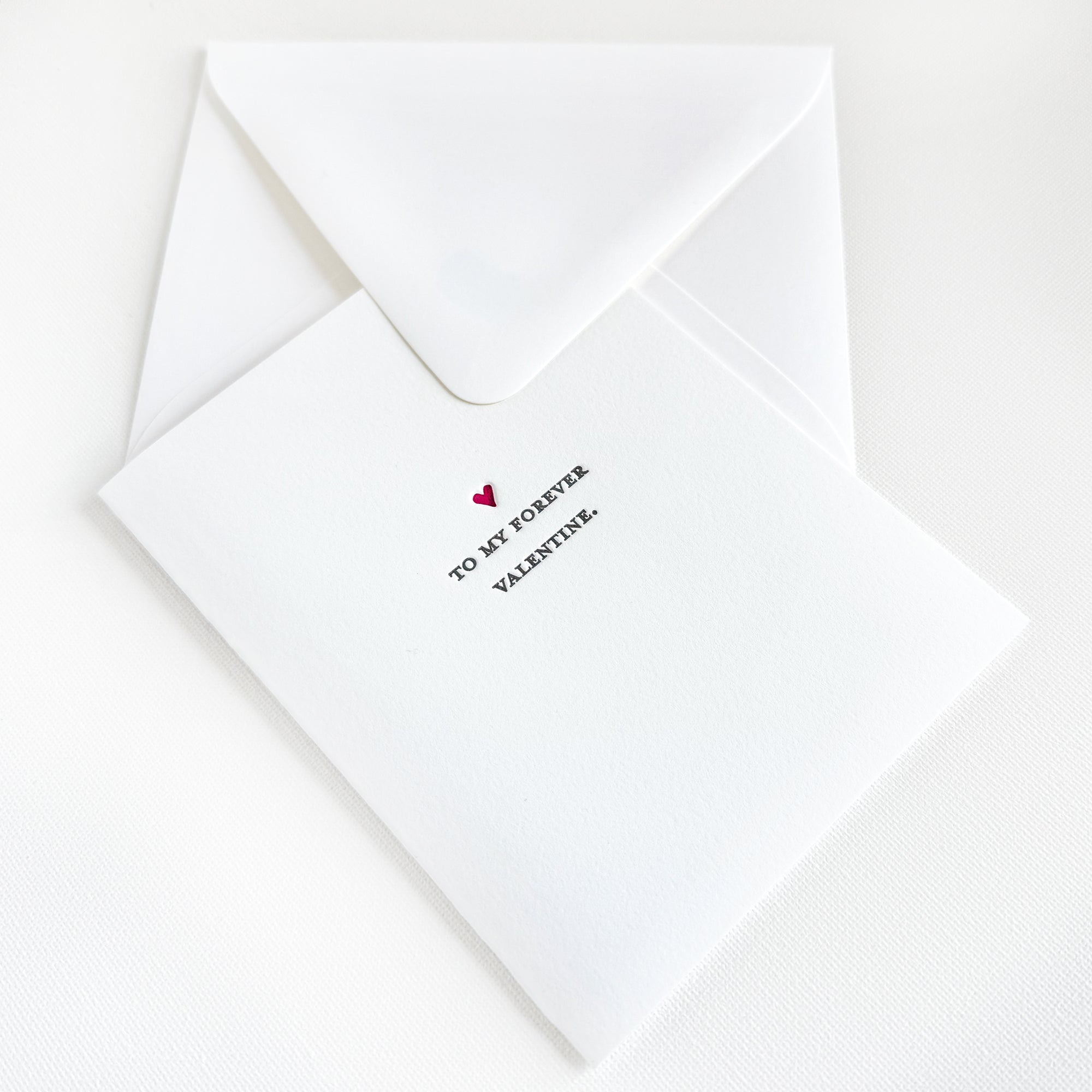 White card with 'To my forever Valentine' text and a heart symbol on a white background

to my forever valentine letterpress greeting card